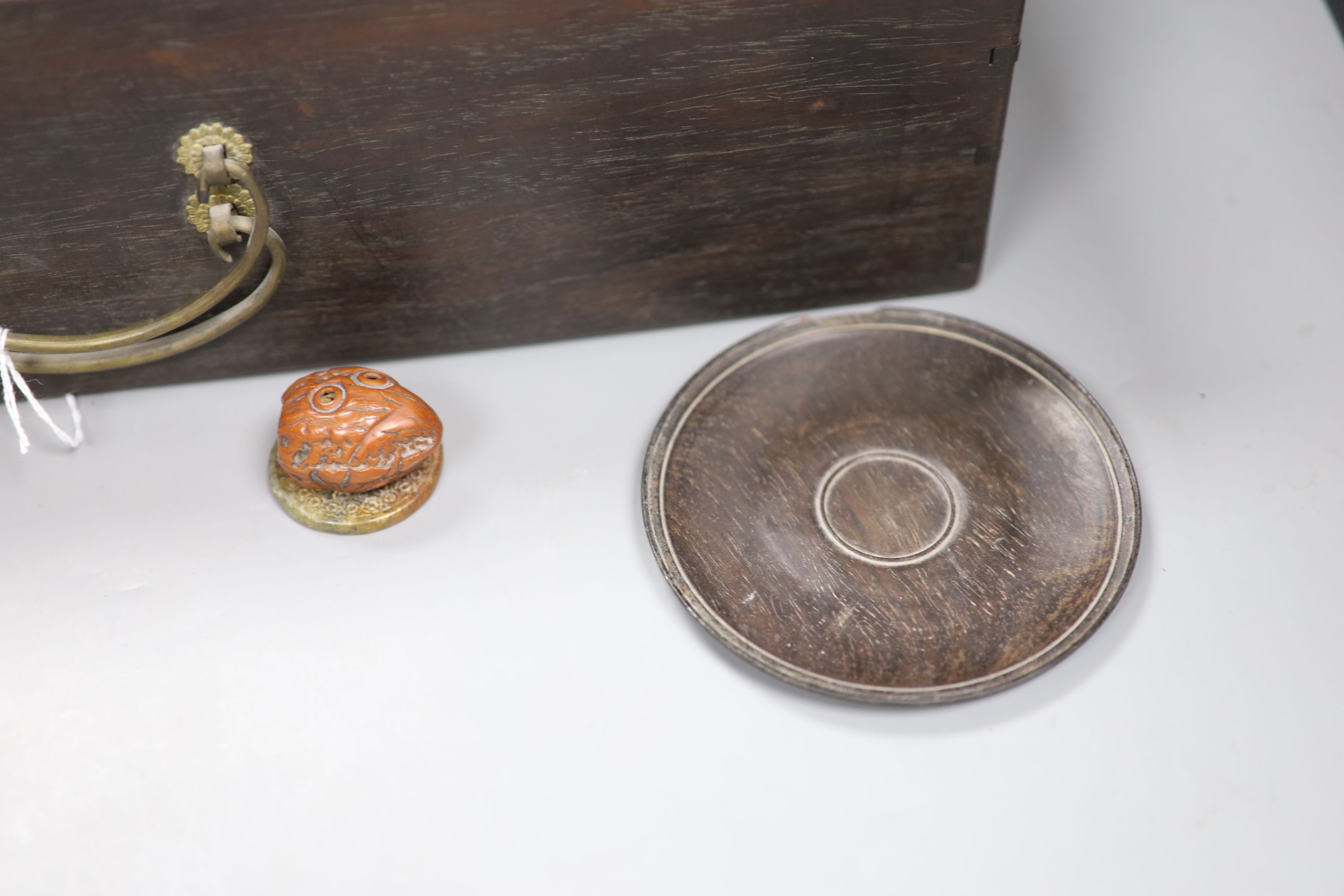 A pair of zitan wood saucers, c. 1800, a Japanese netsuke, c. 1900 an agate pendant of peaches, c.1900, a modern white jade pendant and